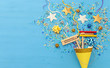 Purim celebration concept (jewish carnival holiday) over wooden blue background.