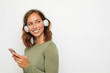 © Martin Villadsen - portrait of a young smiling woman with headphones and mobile phone