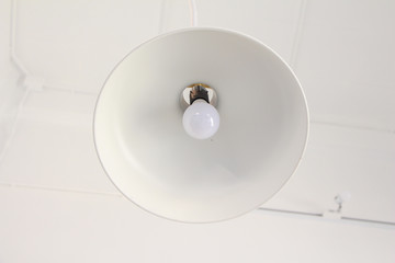 White lamp on the white ceiling.