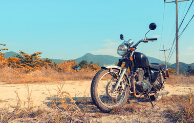 Wall Mural - Motorbike under sky.Vintage color photo effect added