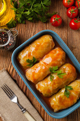 Wall Mural - Traditional stuffed cabbage with minced meat and rice, served in a tomato sauce.