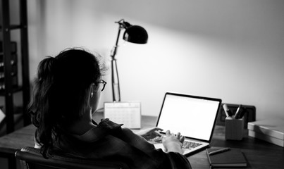 Teen girl doing homework on her laptop