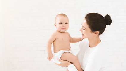 Wall Mural - Mother with baby on bed having good time