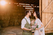 © MZaitsev - lovers in cowboy style stand near hayloft on ranch