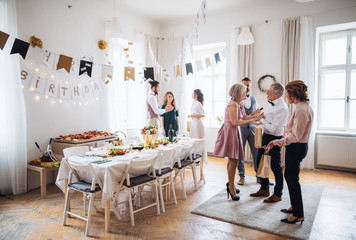 Wall Mural - Multigeneration family with presents on a indoor birthday party.