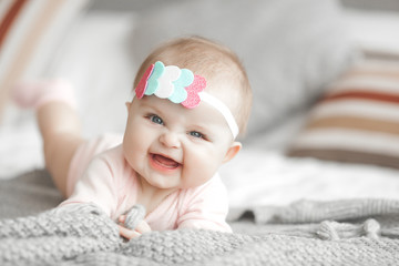 cute litttle baby at home in the bedroom. an infant indoors. 6th month child portrait. adorable cute