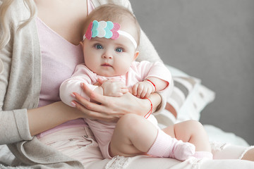 Wall Mural - Cute litttle baby at home in the bedroom. An infant indoors. 6th month child portrait. Adorable cute baby girl.