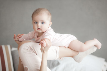 cute litttle baby at home in the bedroom. an infant indoors. 6th month child portrait. adorable cute