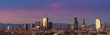 Aerial view of Milan skyline at sunset with alps mountains in the background.