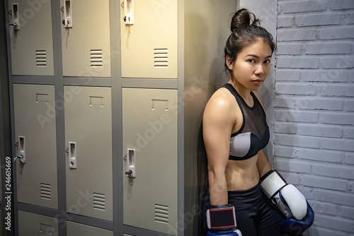 Young Asian Woman Boxer With Boxing Gloves Standing By The