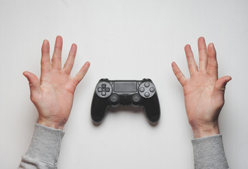 Wall Mural - Hand hold new joystick isolated. Gamer play game with gamepad controller. Gaming man holding simulator joypad. Person with keypad joystic in arms. Sleeve hands hold toy equipment. Modern manipulator.