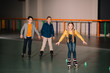 © LIGHTFIELD STUDIOS - Smiling kids in roller skates training on rink