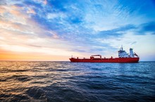 Colorful Sunset Over The North Sea And Tanker Cargo Ship On A Background, Netherlands