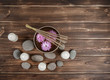 © Iren Moroz - Singing bowl with candles with pebbles on dark wooden background