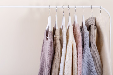 warm knitted clothes hanging on a rack