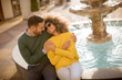 © BGStock72 - Beautiful smiling love couple sitting near fountain on a sunny day