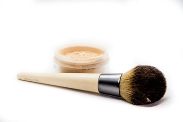 powder with brush for professional makeup on white background