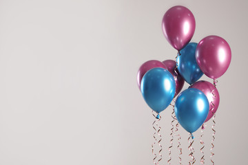 Bright balloons on light background. Space for text