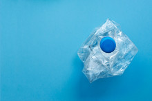 Used Plastic Bottles Crushed And Crumpled Against On The Blue Background. Recycling Concept