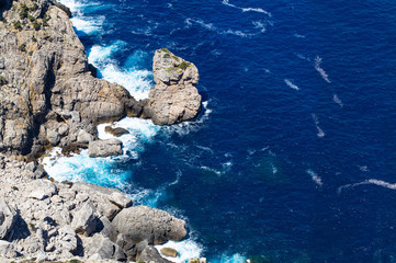 Wall Mural - sea wave breaks on beach rocks landscape.