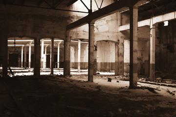 Wall Mural - Old empty abandoned industrial building in sepia color