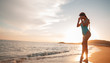 © pha88 - A slender girl on an empty beach.Beautiful sunset and girl