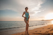 © pha88 - A slender girl on an empty beach.Beautiful sunset and girl