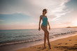 © pha88 - A slender girl on an empty beach.Beautiful sunset and girl