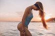 © pha88 - Girl with a gorgeous figure on the sea during sunset.Sexy girl on a wild beach.The girl in the water