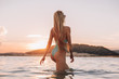 © pha88 - Girl with a gorgeous figure on the sea during sunset.Sexy girl on a wild beach.The girl in the water