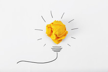 Composition With Crumpled Paper Ball And Drawing Of Lamp Bulb On White Background, Top View. Creative Concept