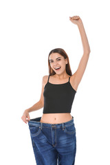 Poster - Slim woman in oversized jeans on white background. Weight loss