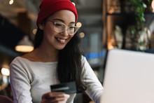 Beautiful Woman Holding Credit Card Using Laptop Computer, Online Shopping With Cash Back, Discount Sales, Low Prices, Saving Money. Money Back Concept. Portrait Of Happy Asian Freelancer At Workplace