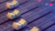 © jojokrap - Slide the button to adjust the volume mixer of audio professionals. In the studio recording.