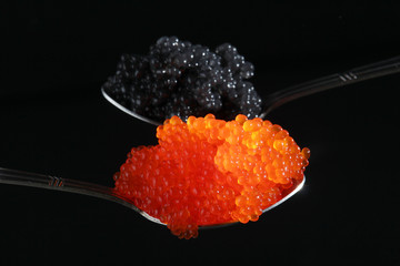 Two spoons with red and black caviar	