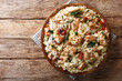 Italian pasta orzo with grilled chicken, dried tomatoes, spinach and cheese close-up. horizontal top view