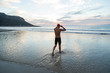 © Southern Light - Senior man preparing to swim in the sea at dawn