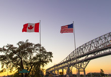 International Border Crossing. Sunset At The Blue Water Bridge Border United States And Canada Crossing. The Bridge Connects Port Huron, Michigan And Sarnia, Ontario.