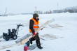 © ads861 - Worker in winter workwear with boards in his hands