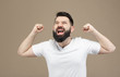 © romandatso - A cute brunette man with a beard in a white T-shirt very happy