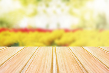 Wall Mural - Empty wooden table with blurred spring background, bokeh of flowers and Park
