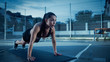© Gorodenkoff - Beautiful Energetic Fitness Girl Doing Push Up Exercises. She is Doing a Workout in a Fenced Outdoor Basketball Court. Evening Shot After Rain in a Residential Neighborhood Area.
