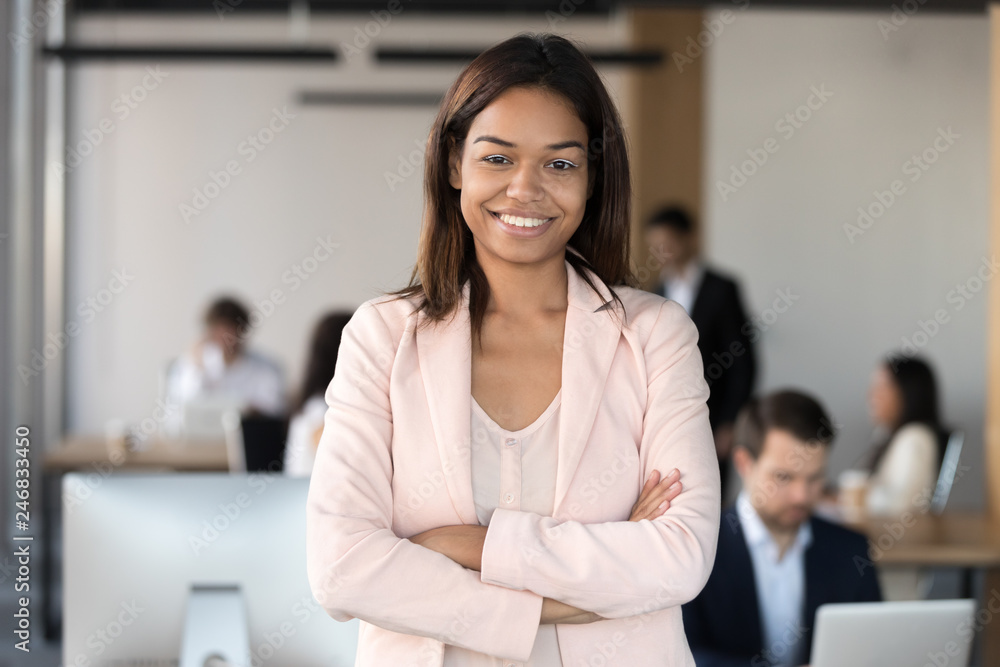 Smiling millennial african american corporate employee executive, mixed race office worker or team leader looking at camera, female young black professional business coach company manager portrait - obrazy, fototapety, plakaty 