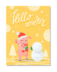 Wall Mural - Hello winter poster with pig in red hat and knitted scarf making snowman outdoors. Piglet in warm cloth on yellow background with trees and snowflakes