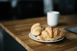 © Gabriela Tulian - Croissant and cup of coffee on wooden table