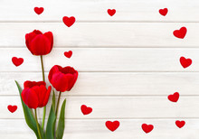 Decoration Of Valentine Day. Beautiful Red Tulips And Hearts On Background Of White Painted Wooden Planks With Space For Text. Top View, Flat Lay