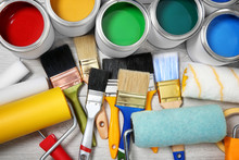 Flat Lay Composition With Cans Of Paint And Decorator Tools On Wooden Background