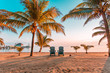 © Ryan Longnecker - Two empty chairs at a beach sunset
