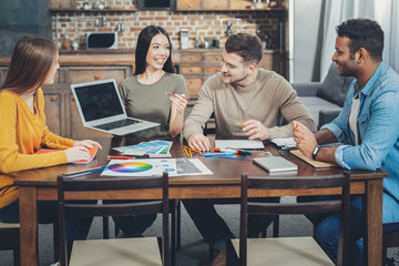 Wall Mural - Merry four colleagues commencing startup