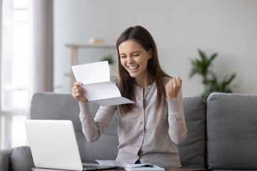 Excited girl student customer holding mail paper letter bank statement feels happy reading great news about admission scholarship, get accepted hired new job employment opportunity, good test results